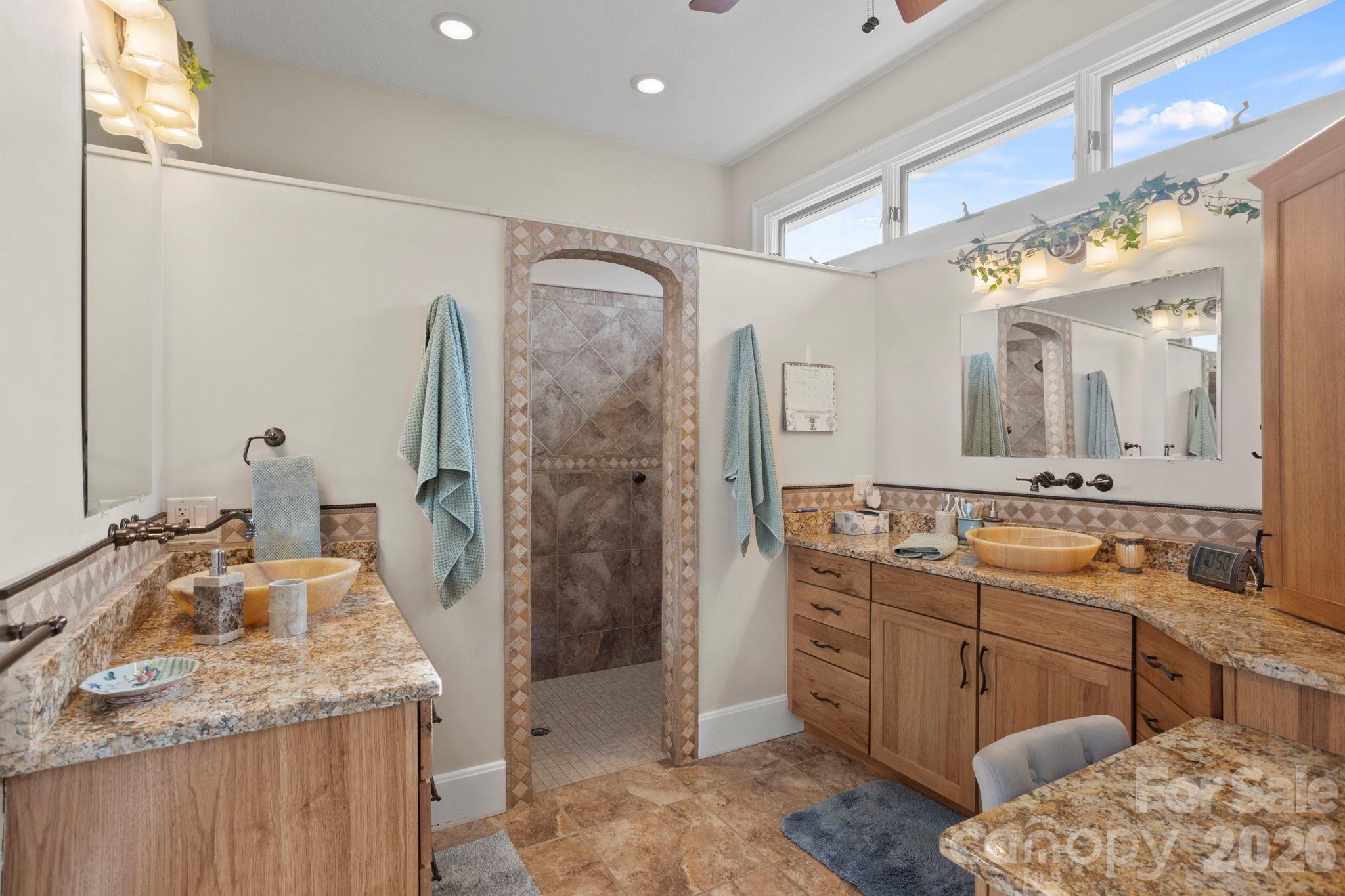 628 Vista Falls Road Mills River, NC 28759 - Photo 20 of 37 a bathroom with a granite countertop sink a mirror and shower