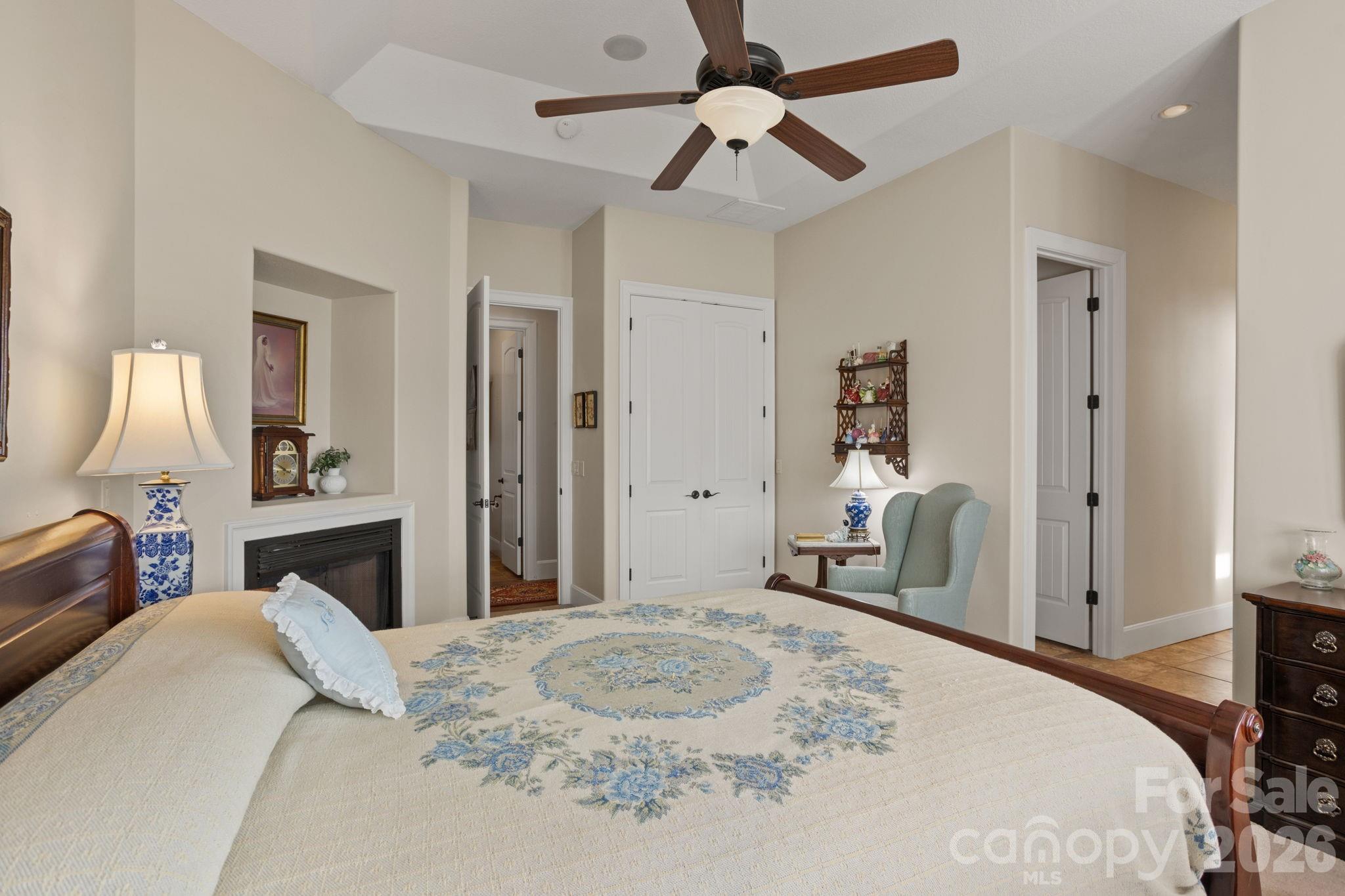 628 Vista Falls Road Mills River, NC 28759 - Photo 21 of 37 a bedroom with a bed wooden floor and a chandelier