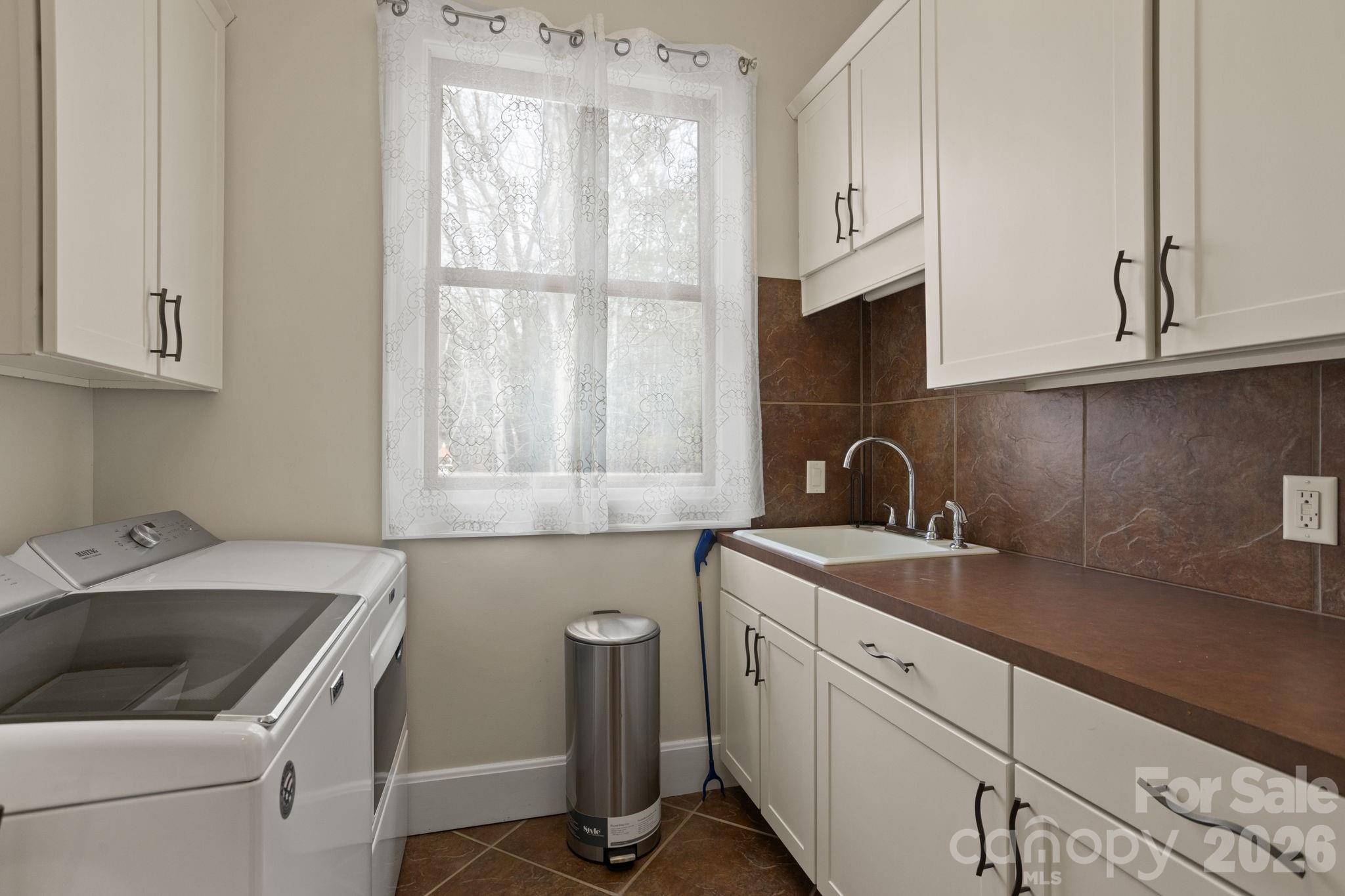 628 Vista Falls Road Mills River, NC 28759 - Photo 25 of 37 a view of a kitchen with sink and washing machine