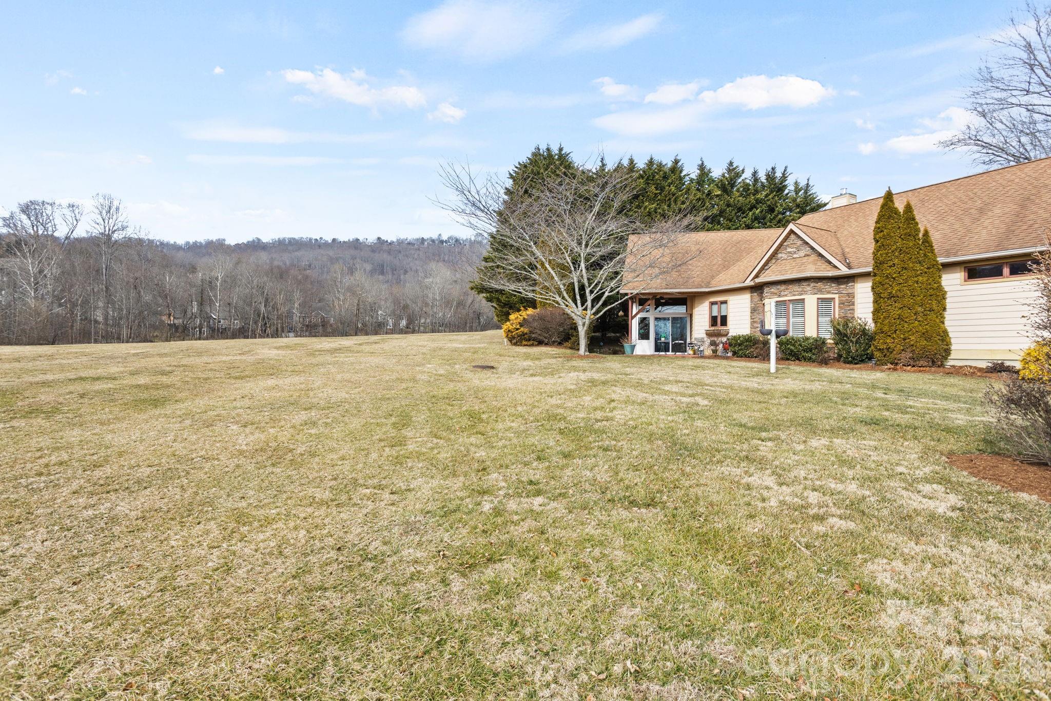 628 Vista Falls Road Mills River, NC 28759 - Photo 35 of 37 a view of a large house with a big yard and large trees