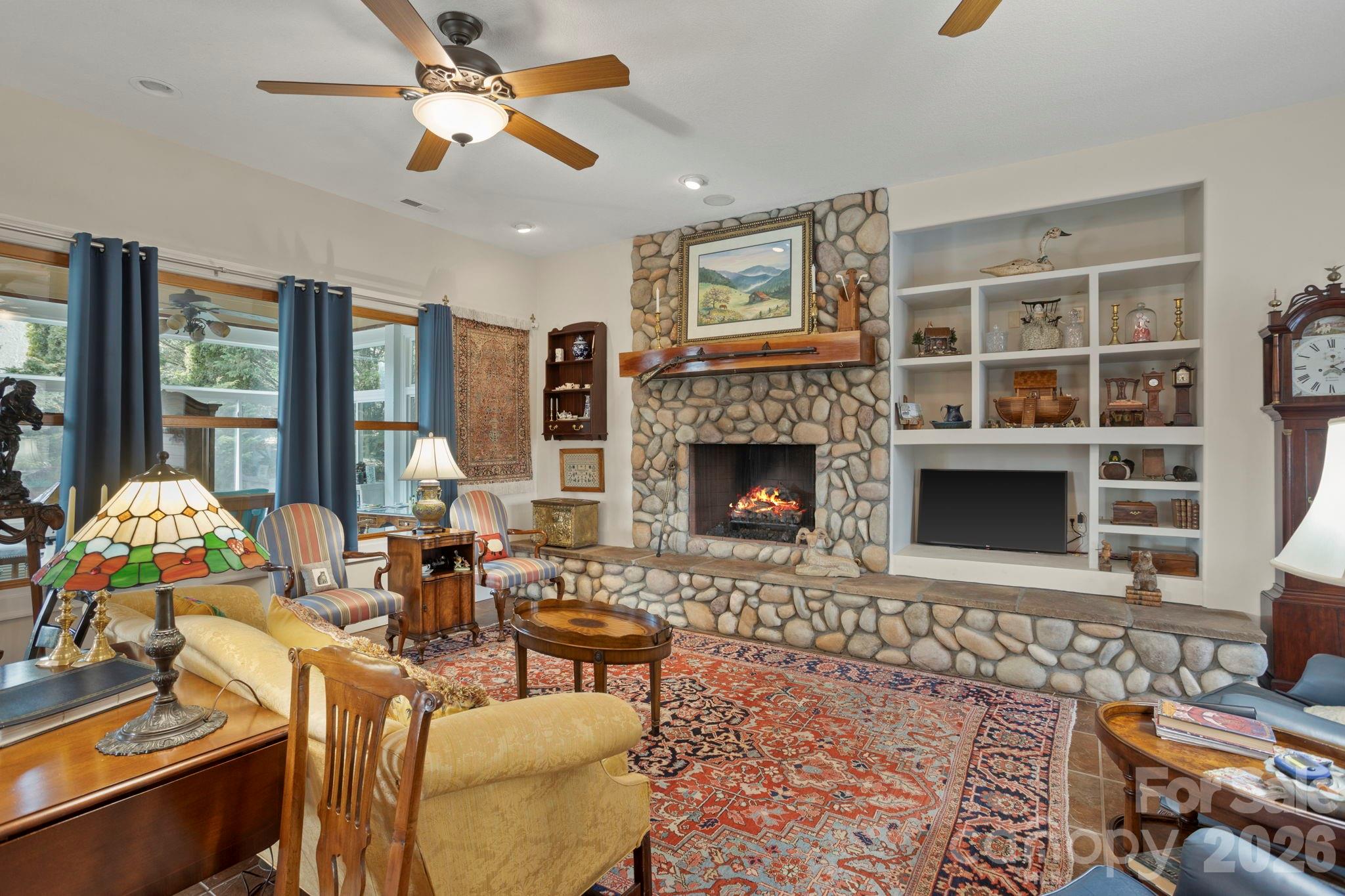 628 Vista Falls Road Mills River, NC 28759 - Photo 10 of 37 a living room with furniture a fireplace and a flat screen tv