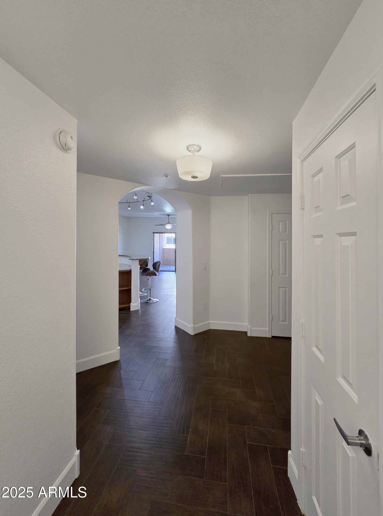 920 East Devonshire Avenue, Unit 2009 Phoenix, AZ 85014 - Photo 2 of 24 a view of a hallway with wooden floor and a bathroom