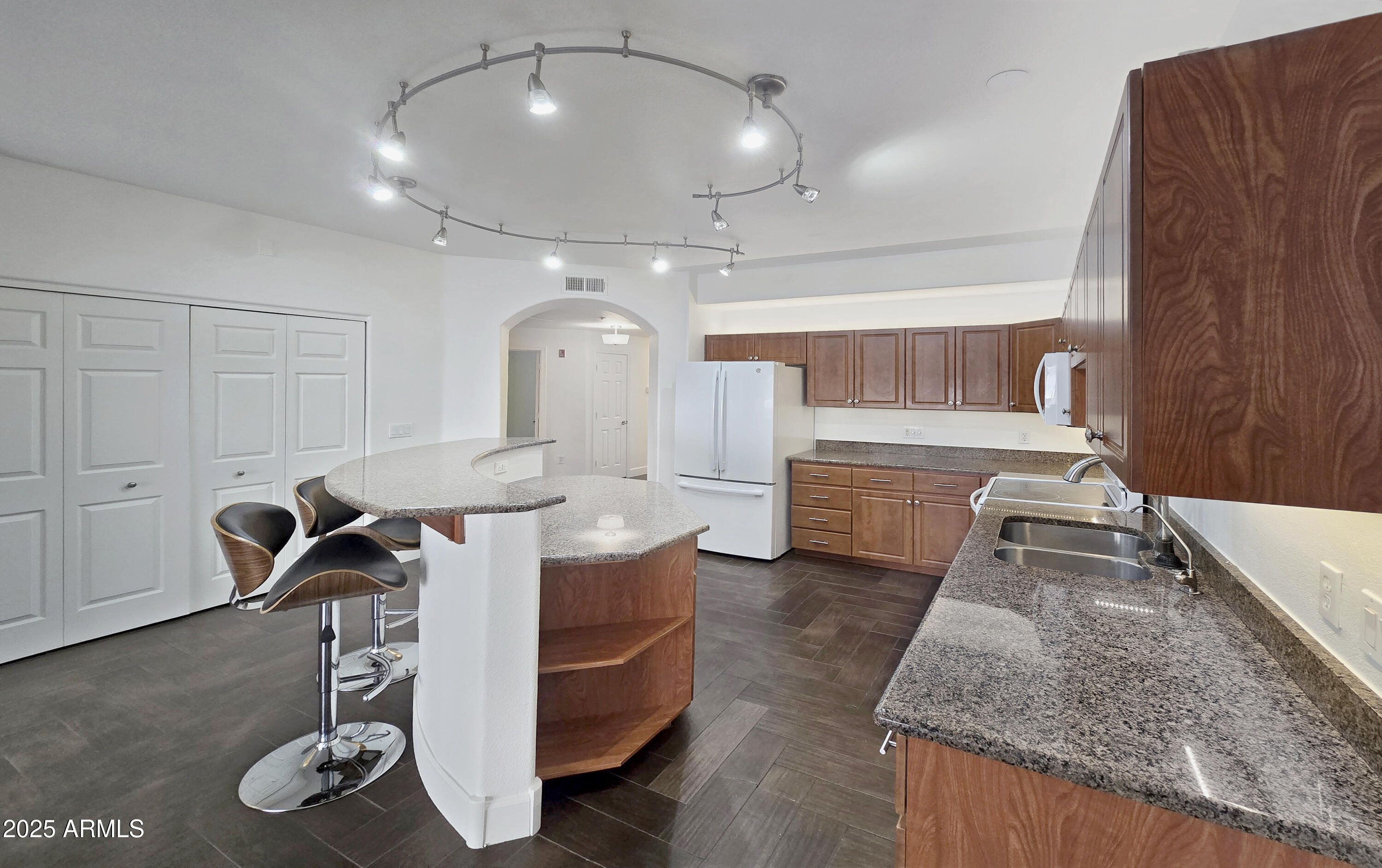 920 East Devonshire Avenue, Unit 2009 Phoenix, AZ 85014 - Photo 5 of 24 a view of a kitchen with kitchen island a counter top space a sink stainless steel appliances and cabinets