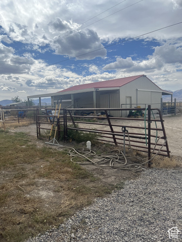 3839 Marshall Road Erda, UT 84029 - Photo 25 of 42 Metal outbuilding with a red metal roof and extended covered space