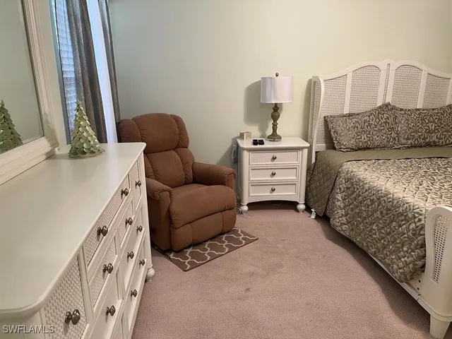 a bedroom with furniture and a baby crib