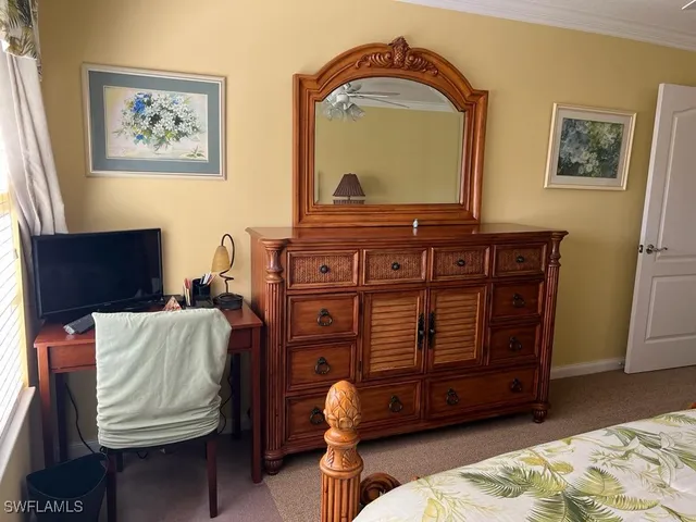 a living room with furniture and a mirror
