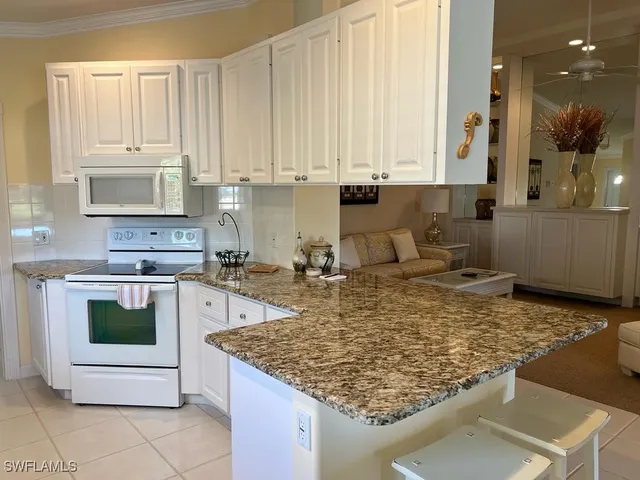 a kitchen with a stove sink and cabinets
