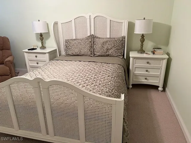 a bedroom with a bed and dresser