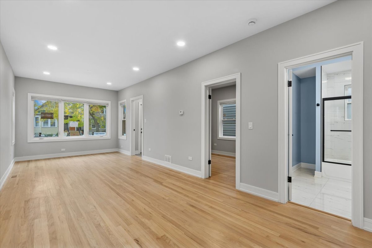 2159 North Parkside Avenue Chicago, IL 60639 - Photo 4 of 27 wooden floor in an empty room with a window