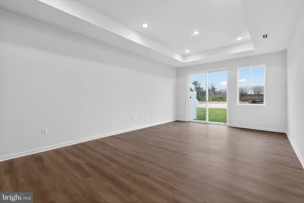 a view of a room with wooden floor and window