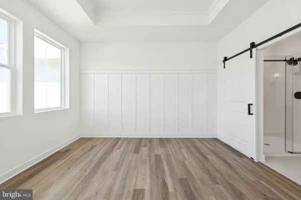 a view of a room with wooden floor closet and windows
