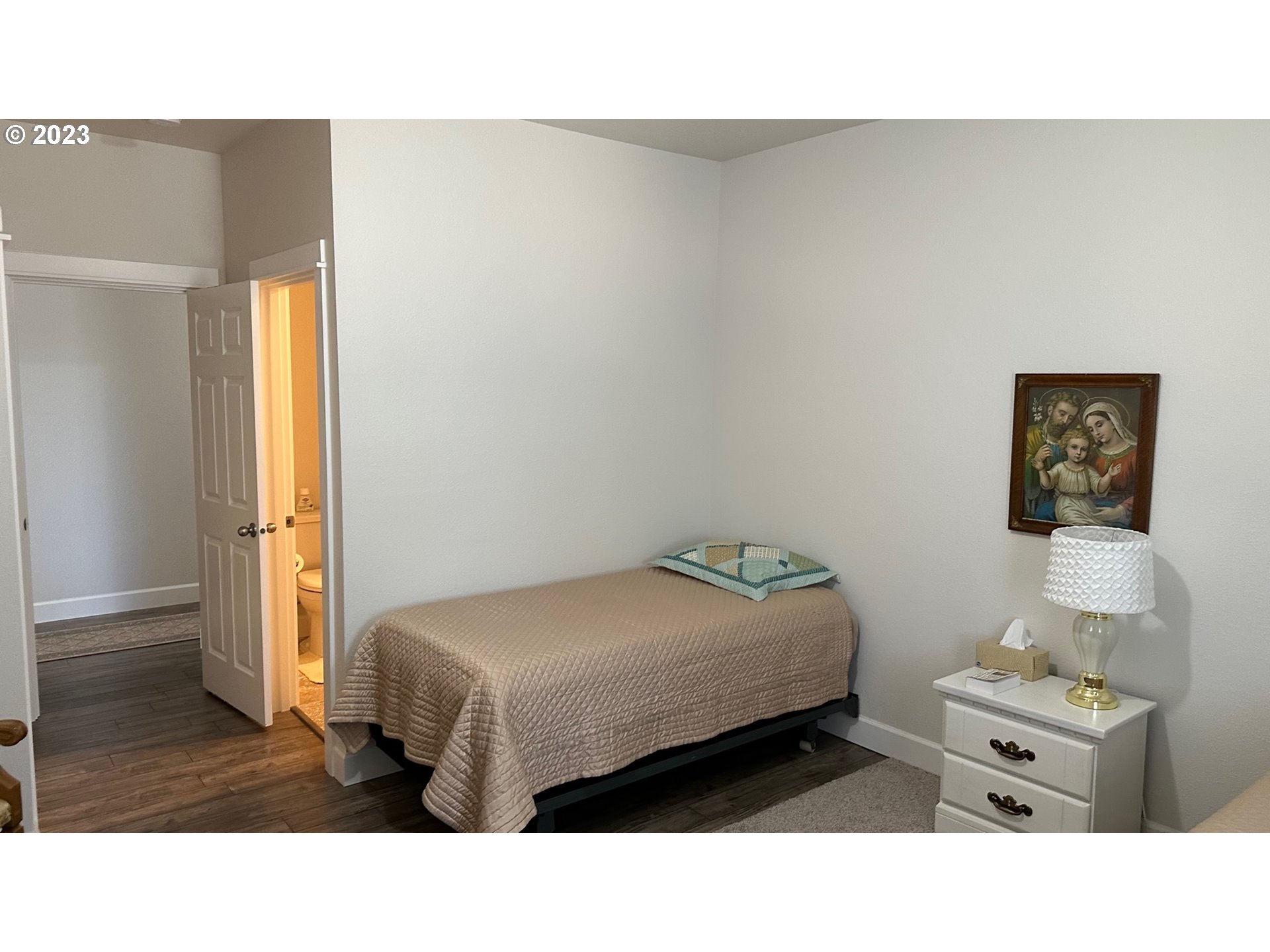 746 Divot Loop Sutherlin, OR 97479 - Photo 11 of 32 a bedroom with a bed and wooden floor