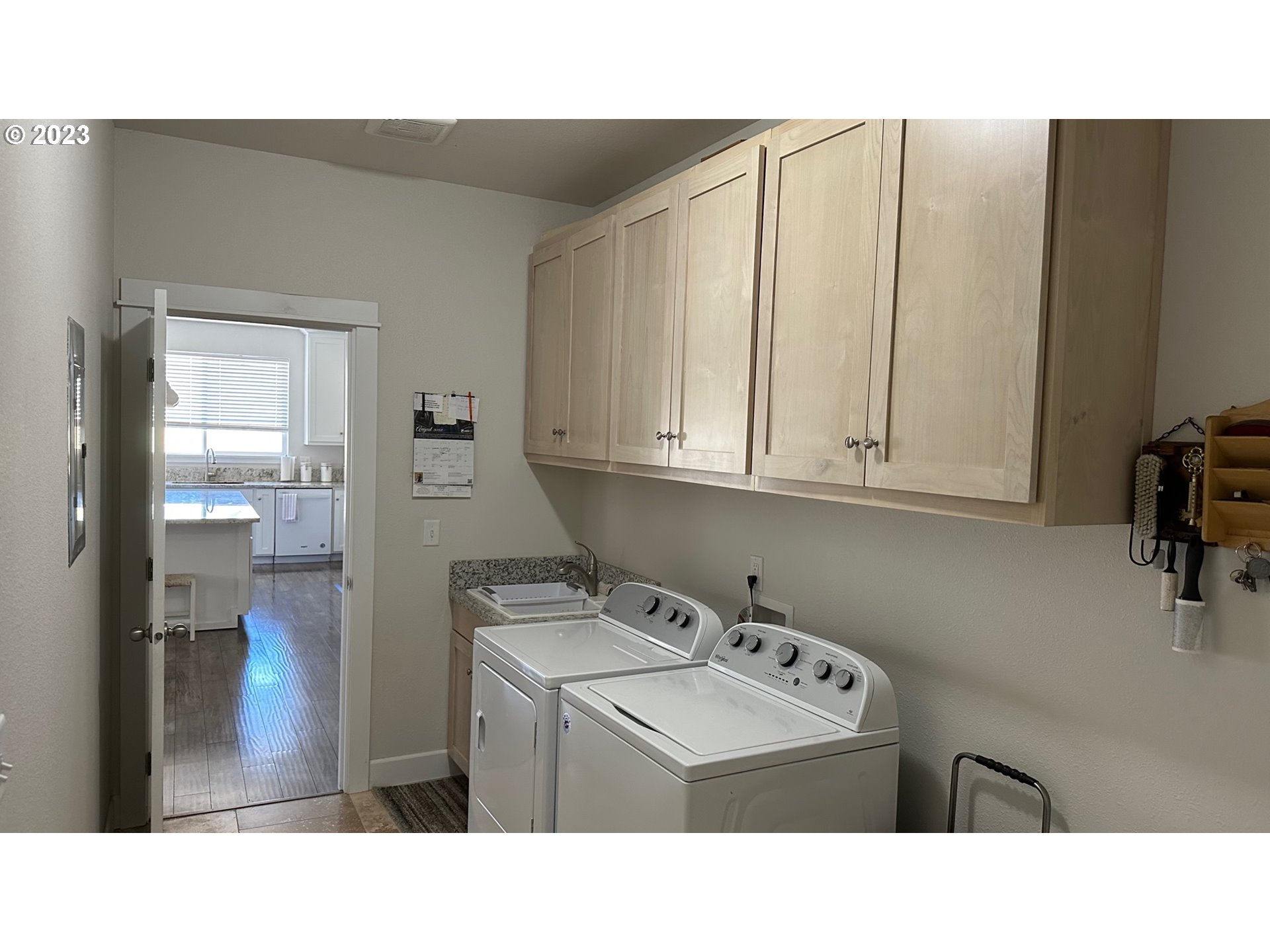 746 Divot Loop Sutherlin, OR 97479 - Photo 15 of 32 a kitchen with a sink a refrigerator and cabinets
