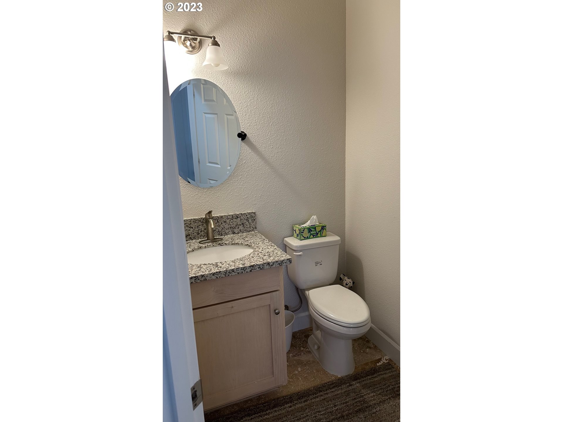 746 Divot Loop Sutherlin, OR 97479 - Photo 18 of 32 a bathroom with a granite countertop toilet a sink and a mirror
