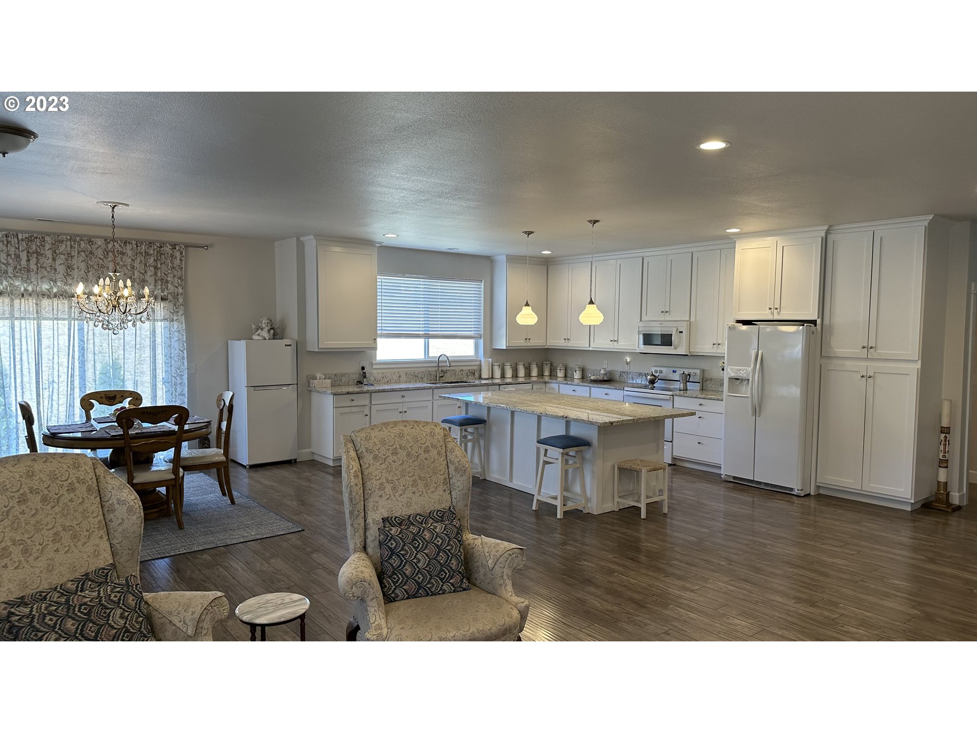 746 Divot Loop Sutherlin, OR 97479 - Photo 2 of 32 a kitchen with refrigerator and chairs