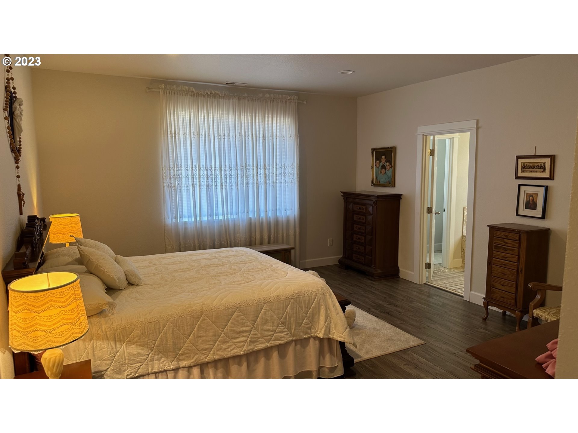 746 Divot Loop Sutherlin, OR 97479 - Photo 4 of 32 a bedroom with a bed and wooden floor