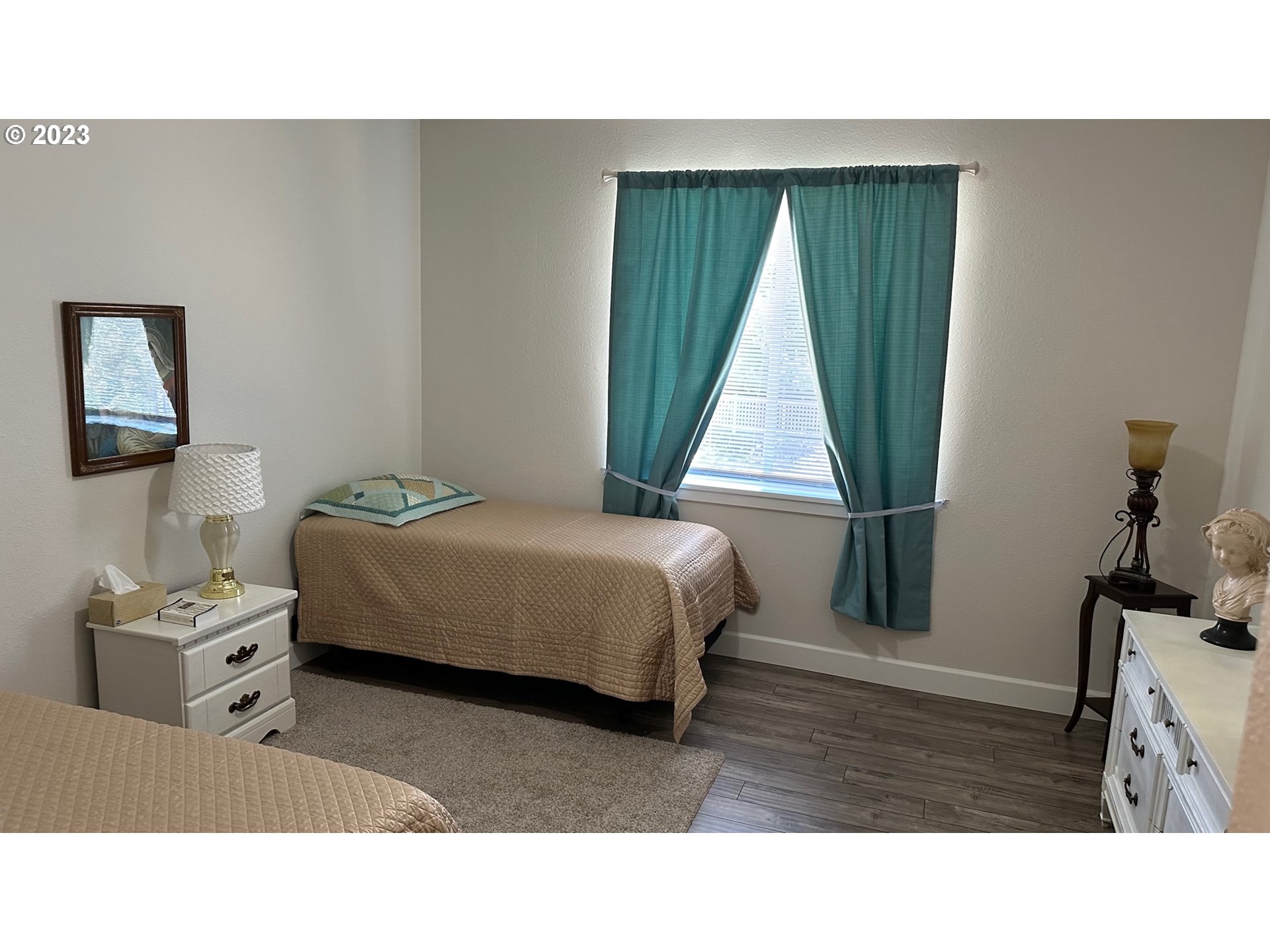746 Divot Loop Sutherlin, OR 97479 - Photo 10 of 32 a living room with a bed furniture and a window