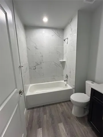 a bathroom with a toilet and a bathtub