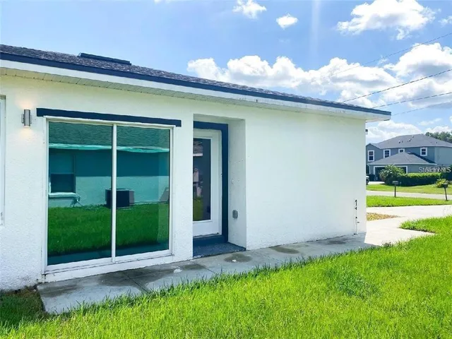 a view of a house with a yard and plants