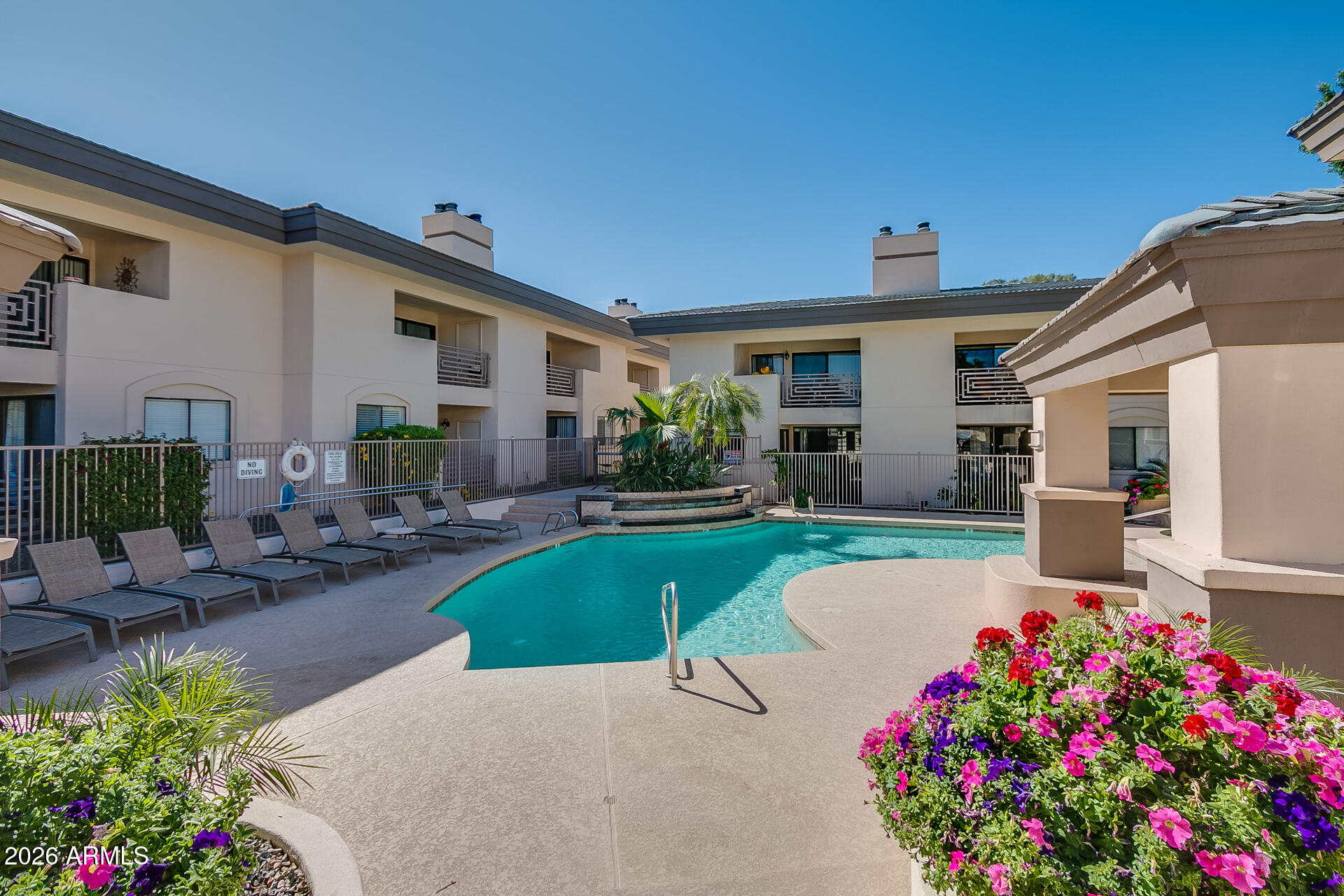 3235 East Camelback Road, Unit 211 Phoenix, AZ 85018 - Photo 15 of 17 a view of a house with swimming pool