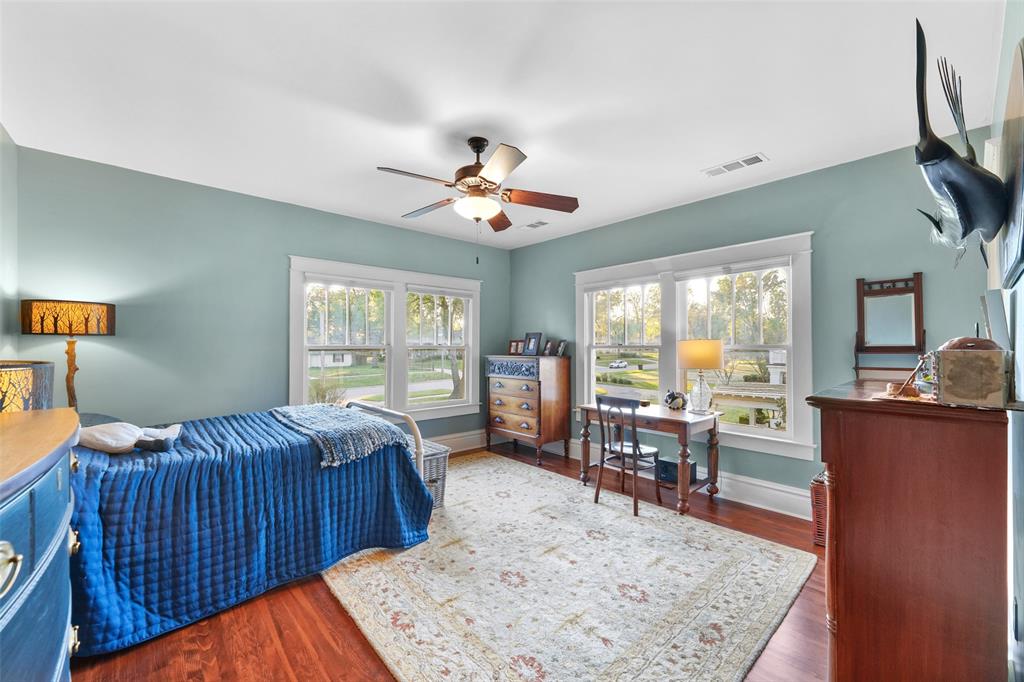 406 Griffith Avenue Terrell, TX 75160 - Photo 33 of 40 This room features hardwood floors, light blue walls, and a ceiling fan