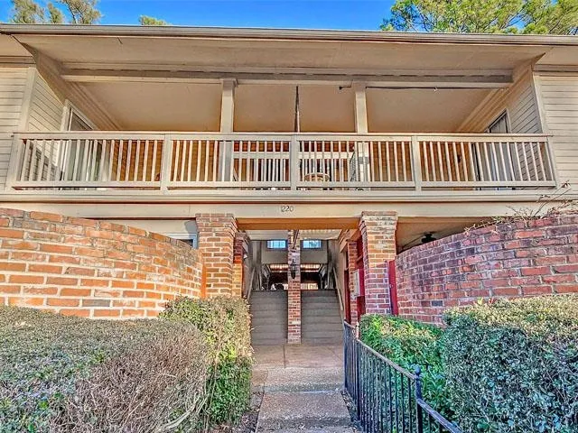 a view of a brick house with many windows