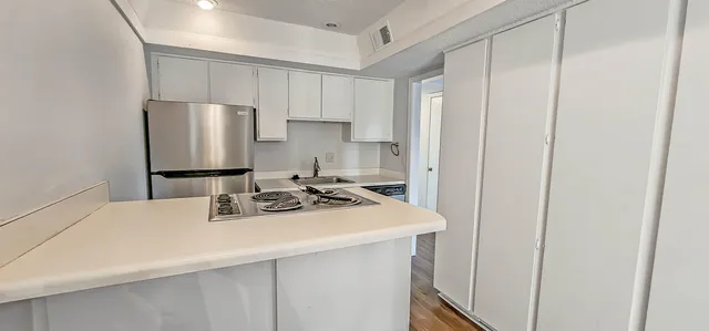 a kitchen with a sink a refrigerator and a stove