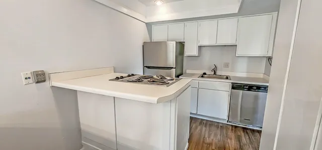 a kitchen with stainless steel appliances white cabinets and a sink
