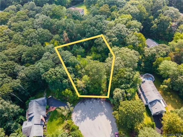 an aerial view of a house with a yard and outdoor seating