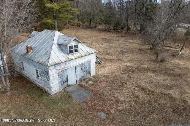a view of a wooden house with a yard
