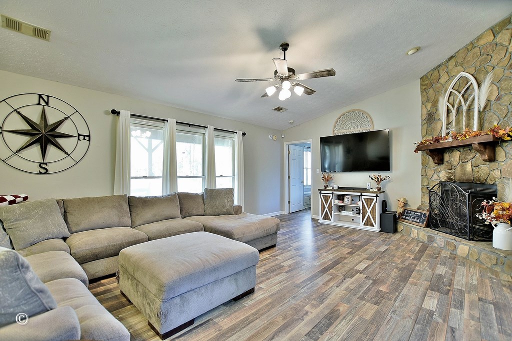 129 Hunter Road Cataula, GA 31804 - Photo 11 of 28 a living room with furniture and a flat screen tv with wooden floor