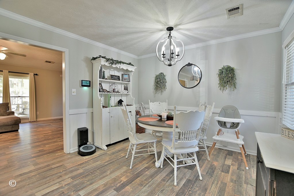 129 Hunter Road Cataula, GA 31804 - Photo 14 of 28 a view of a dining room with furniture wooden floor and chandelier