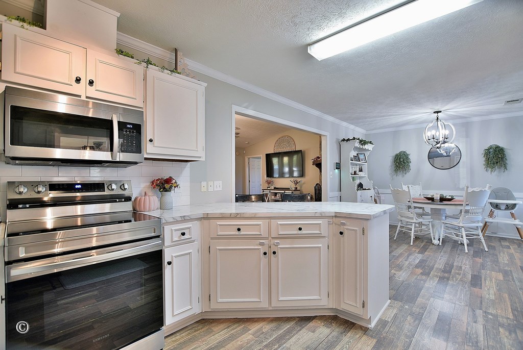 129 Hunter Road Cataula, GA 31804 - Photo 15 of 28 a kitchen with stainless steel appliances white cabinets and a stove top oven
