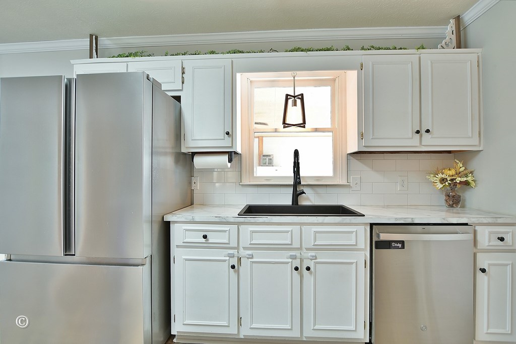 129 Hunter Road Cataula, GA 31804 - Photo 16 of 28 a kitchen with stainless steel appliances granite countertop a refrigerator and white cabinets