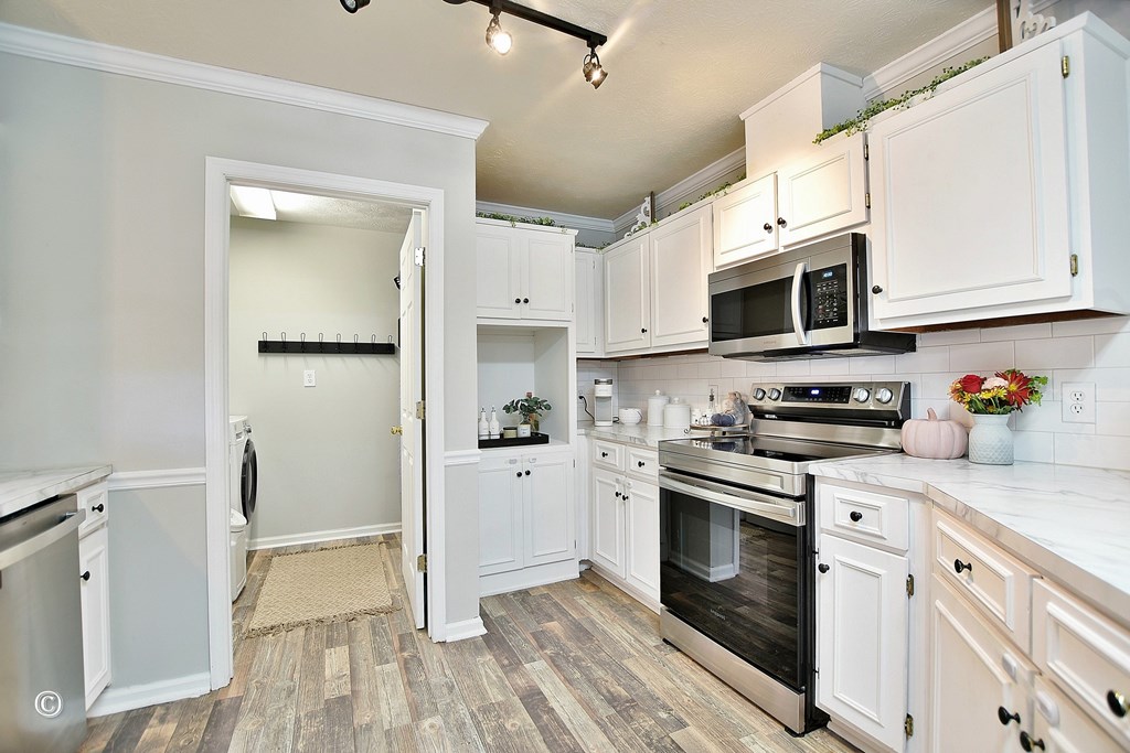 129 Hunter Road Cataula, GA 31804 - Photo 17 of 28 a kitchen with stainless steel appliances granite countertop cabinets and a stove top oven
