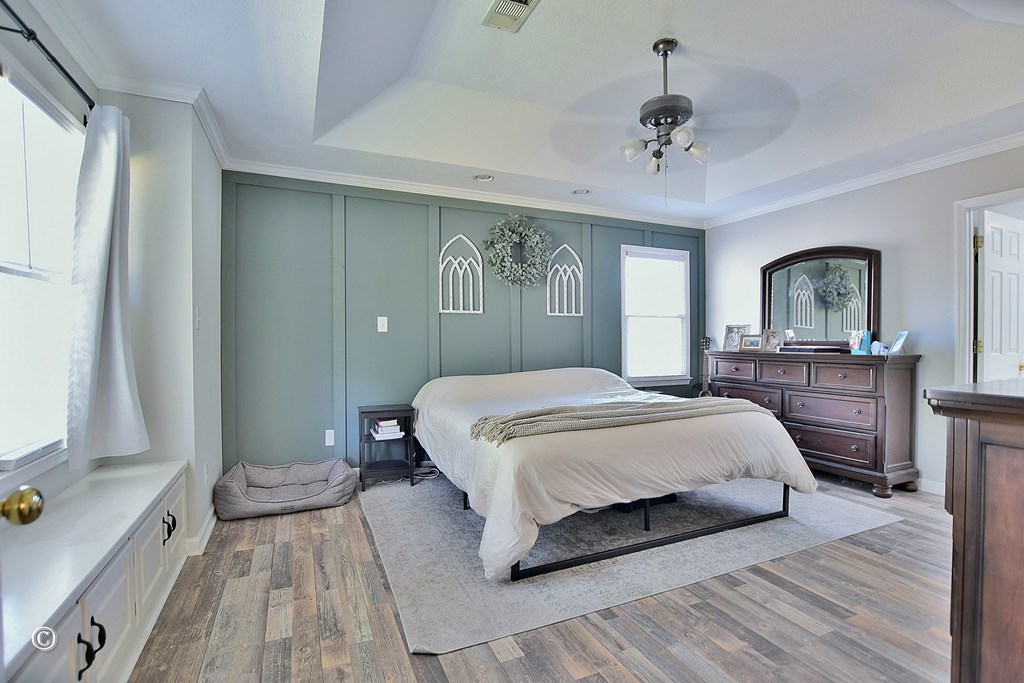 129 Hunter Road Cataula, GA 31804 - Photo 19 of 28 a spacious bedroom with a large bed and a chandelier