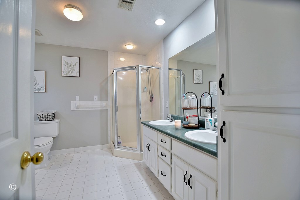 129 Hunter Road Cataula, GA 31804 - Photo 21 of 28 a bathroom with a double vanity sink and a mirror