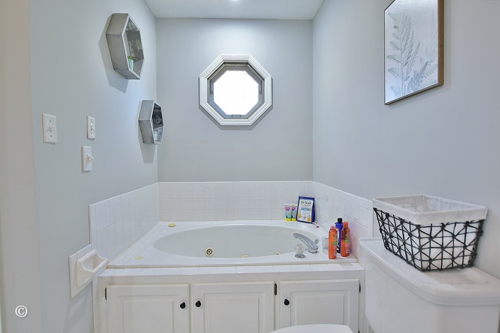 129 Hunter Road Cataula, GA 31804 - Photo 22 of 28 a bathroom with a bathtub sink and mirror