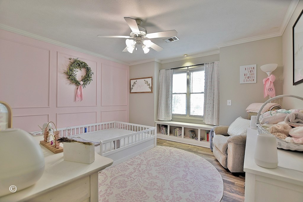 129 Hunter Road Cataula, GA 31804 - Photo 25 of 28 a spacious bedroom with a bed and a couch