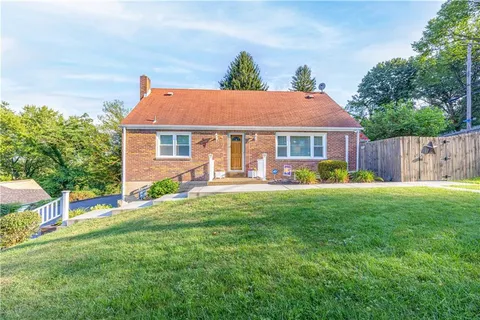 a view of a house with a yard and a garden