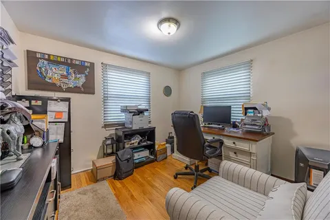a view of a workspace with furniture and a window