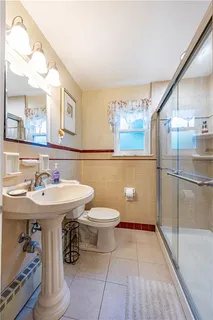 a bathroom with a sink a toilet and mirror