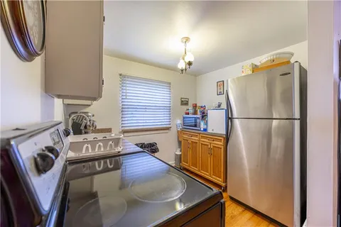 a kitchen with stainless steel appliances granite countertop a refrigerator a stove and a sink
