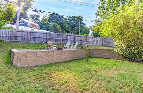 a view of a backyard with sitting area