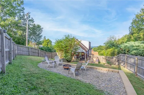 a front view of a house with a yard table and chairs