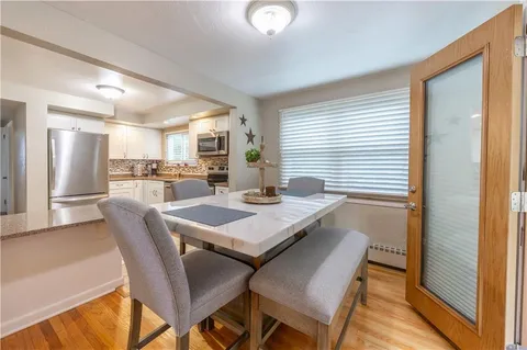 a view of a dining room with furniture and window