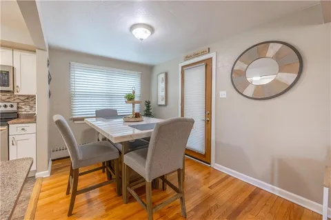 a dining room with furniture and wooden floor