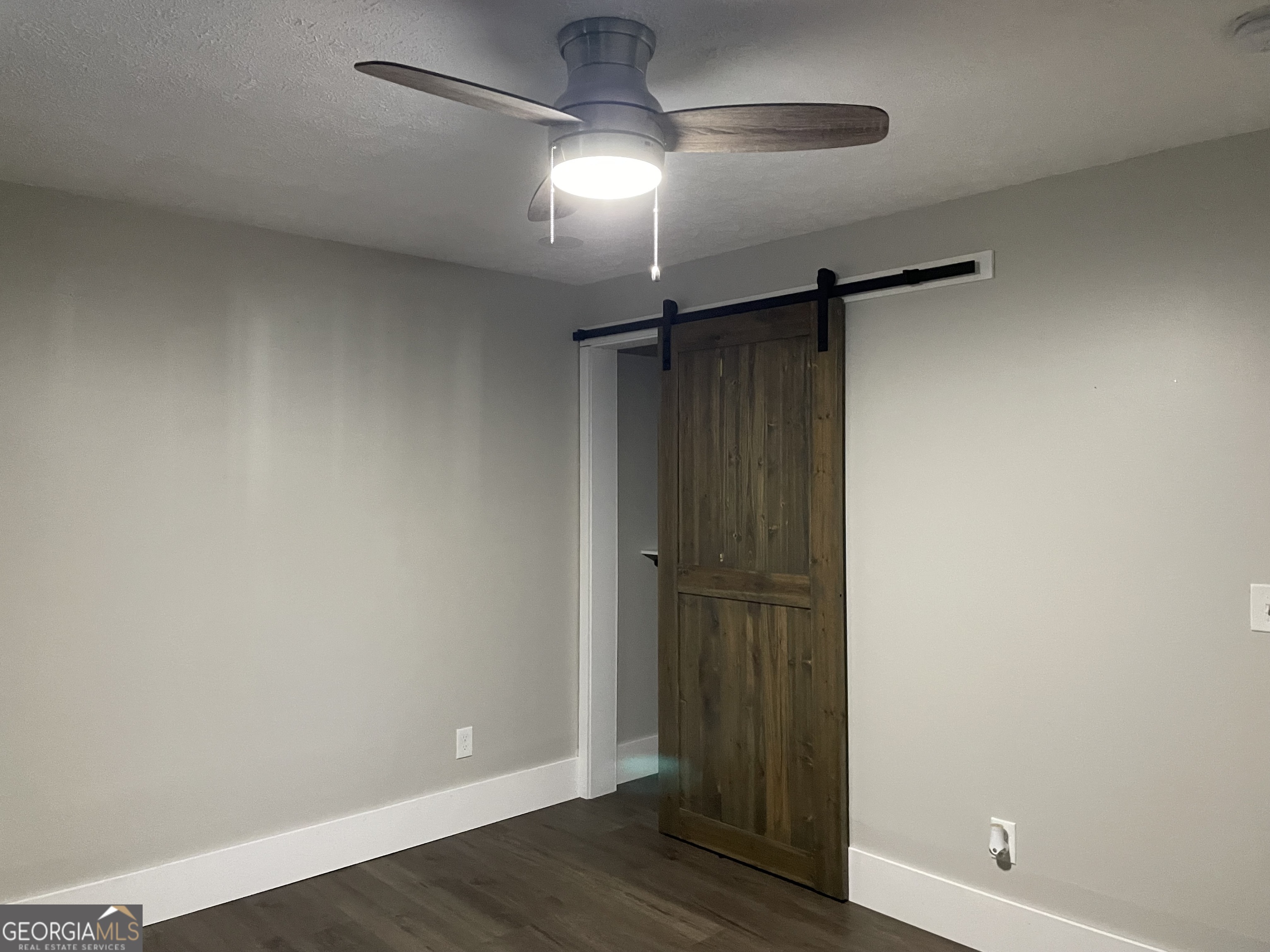 5186 Wheat Street Northeast Covington, GA 30014 - Photo 4 of 10 an empty room with wooden floor and windows