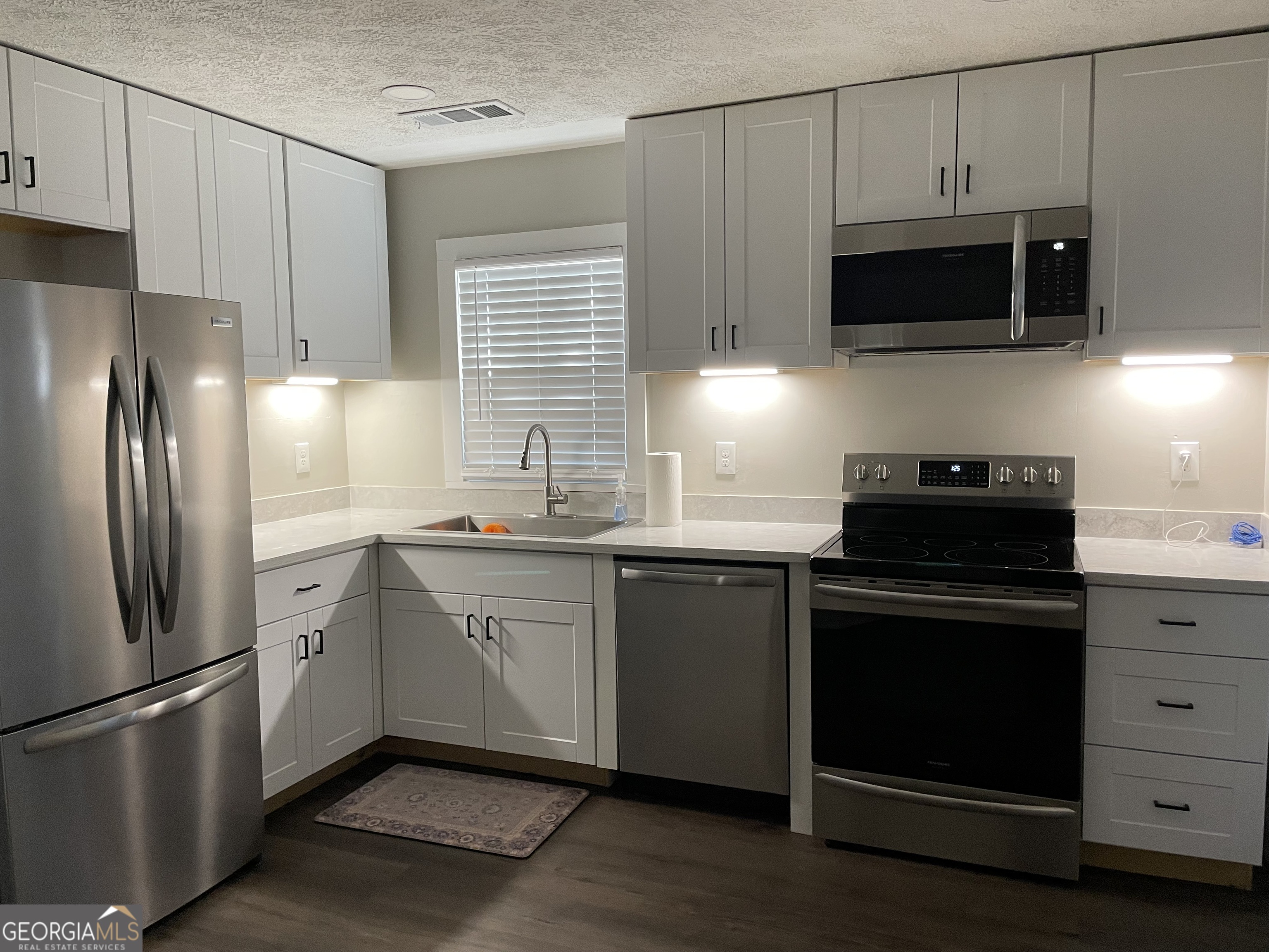 5186 Wheat Street Northeast Covington, GA 30014 - Photo 9 of 10 a kitchen with a refrigerator stove and microwave