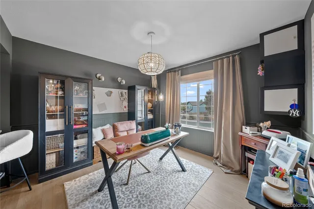 a bedroom with a bed and a desk